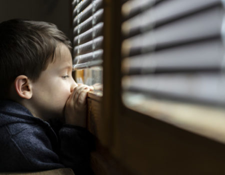 sad-boy-looking-through-window